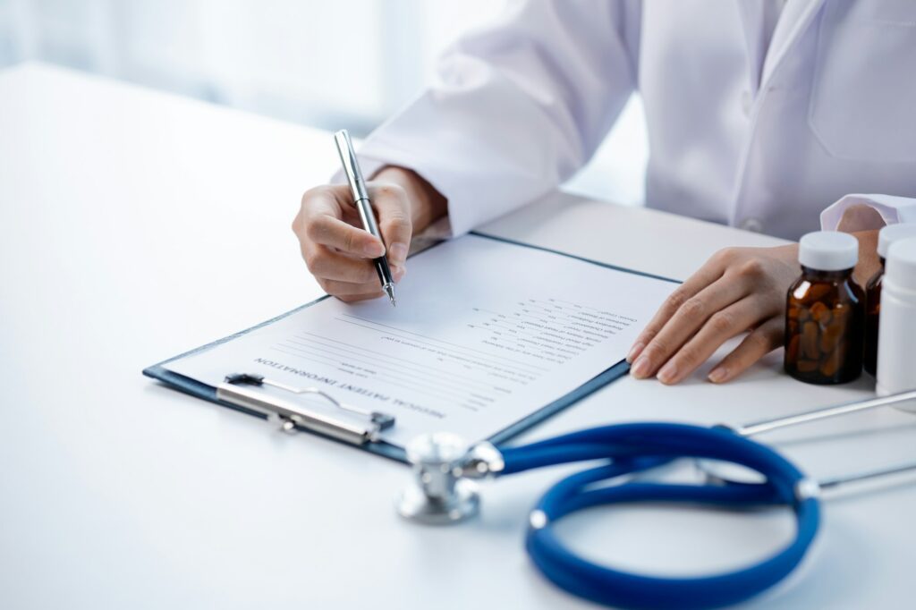 Doctors looking at patient's diagnostic documentation in the hospital's medical room.