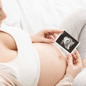 Pregnant woman enjoying her baby ultrasound image